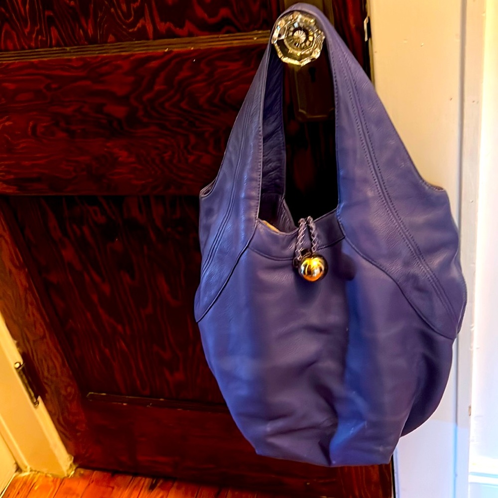 Gently used huge Bill Blass buttery leather bag w/ zipper pockets inside & out.